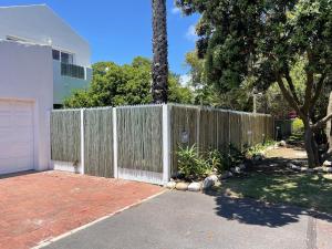 a wooden fence in front of a house at Rest@Kommetjie in Cape Town