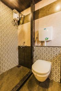 a bathroom with a toilet and a shower at Hotel Golden Crown in Mumbai