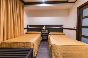 Postel nebo postele na pokoji v ubytování Hotel Machaco