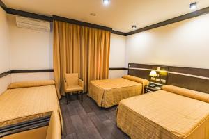Postel nebo postele na pokoji v ubytování Hotel Machaco