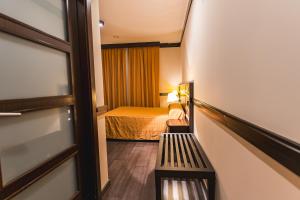 Postel nebo postele na pokoji v ubytování Hotel Machaco