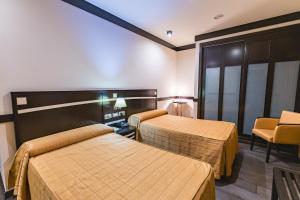 Postel nebo postele na pokoji v ubytování Hotel Machaco