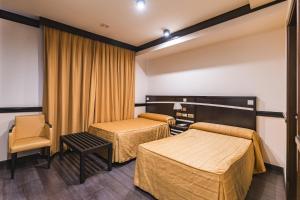 Postel nebo postele na pokoji v ubytování Hotel Machaco