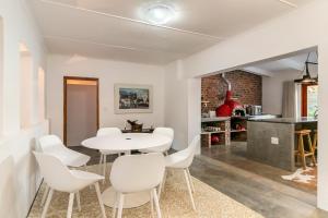 a dining room with a white table and white chairs at Aardvark Bioreserve in Ladismith