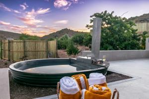 a jacuzzi tub with a view of the mountains at Aardvark Bioreserve in Ladismith