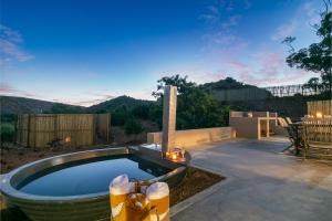a swimming pool in a yard with a table and chairs at Aardvark Bioreserve in Ladismith