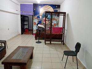 a room with a bed and a table and chairs at Anli in Tonalá