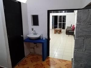 a bathroom with a sink and a room at Anli in Tonalá