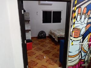 a door to a room with a painting on the wall at Anli in Tonalá