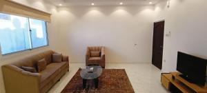 a living room with a couch and a tv at دانة - Dana in Medina