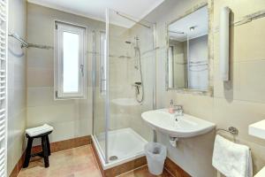 a white bathroom with a sink and a shower at Chalet Sabrina in Kaprun +32 photos