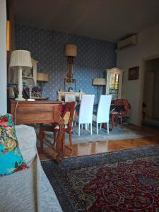 a living room with a piano and chairs and a table at Heart of Verona in Verona