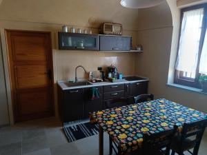 a small kitchen with a table and a sink at BugyGattolo in Boves