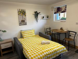 a bedroom with a bed and a table with chairs at Stardust Getaway Tiny-Home E32AK40 in Piltown