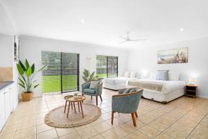 a bedroom with a bed and a table and chairs at Palm Cove House in Trivia in Palm Cove