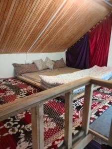 a couple of beds in a room at Mother's eco lodge in Jibhi