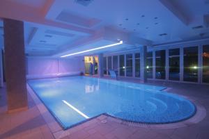 a large swimming pool in a large building at Hotel Golf in Kruševac