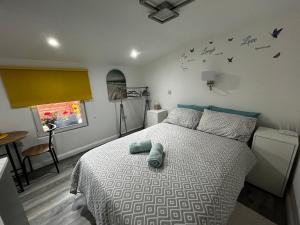 PiltownStardust Studio E32AK40的一间卧室设有一张床,墙上设有一扇带蝴蝶的窗户。