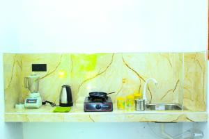 a kitchen counter with a sink and a blender at White rose villa in Weligama