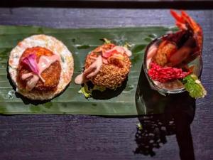 three different types of food on a green tray at Lotus Villa Kandy in Peradeniya
