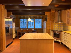 a large kitchen with a large island in the middle at Villa Vielma in Levi