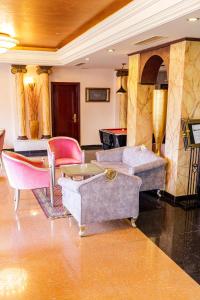 a living room with couches and tables and chairs at Cesar Palace Sousse in Sousse