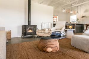 a living room with a coffee table and a fireplace at Aardvark Bioreserve in Ladismith