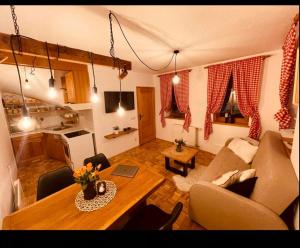 a living room with a couch and a table at Apartma Orhideja in Moravske Toplice
