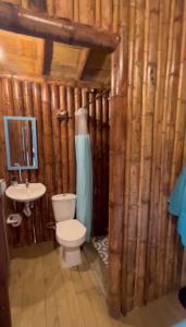 a bathroom with a toilet and a sink at Glamping Caribe con bar y bañera privada in Sopetran