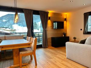 a living room with a table and a couch at Alpen Studio Ellmau III in Ellmau