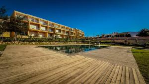 a swimming pool in front of a building at Luxueux Wave Swing Stay in Taghazout
