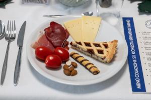 a plate of food with cheese and meat and vegetables at B&B I LAKE IT BELLAGIO in Bellagio
