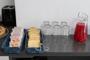 a table with two sandwiches and two glasses of juice at B&B I LAKE IT BELLAGIO in Bellagio