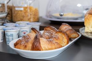 a plate of croissants and other pastries on a counter at B&B I LAKE IT BELLAGIO in Bellagio