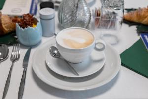 a cup of coffee on a plate on a table at B&B I LAKE IT BELLAGIO in Bellagio