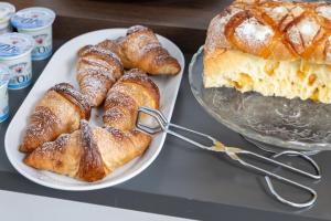 a table with two plates of pastries and a cake at B&B I LAKE IT BELLAGIO in Bellagio