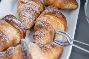 a plate of pastries with powdered sugar on it at B&B I LAKE IT BELLAGIO in Bellagio