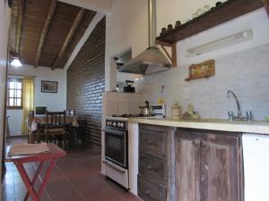 a kitchen with a sink and a stove top oven at La Martina Casa de Campo in San Rafael