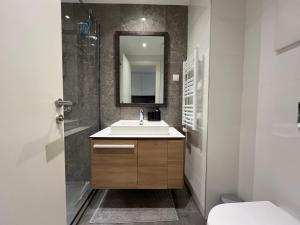 a bathroom with a sink and a mirror at Belgrade Waterfront River View Apartments in Belgrade
