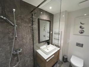 a bathroom with a sink and a shower at Belgrade Waterfront River View Apartments in Belgrade