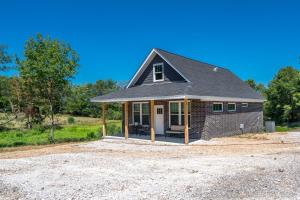 a house being constructed on a gravel lot at The Betty, on 2 acres Hot tub & 2 King Beds in Hot Springs