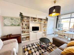 a living room with a couch and a tv at Apartment Sagrera in Barcelona