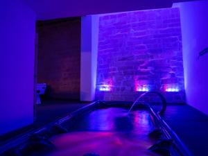 a dark room with a hot tub with purple lights at Villa Gaia - Sunset Views, Indoor Heated Pool, Sauna and Games Room in Mellieħa +60 photos