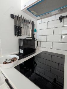 a kitchen with a counter with a toaster and a microwave at Kopaonička priča in Kopaonik +56 photos