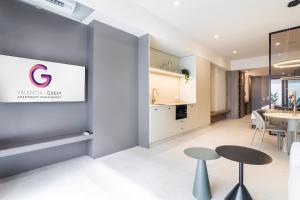 a rendering of a living room and dining room with a table and chairs at North Station PEN-SUITES in Valencia +47 photos