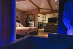 a bedroom with a bed and a living room with a tub at L Atelier by VIP in Saint Die