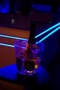 a bottle in a glass of water on a table at L Atelier by VIP in Saint Die +18 photos