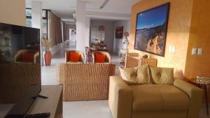 a living room with a couch and chairs at Recanto sol nascente in Rio Formoso