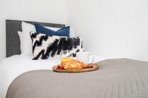 een dienblad met eten en drinken op een bed bij 3 BDR House near East Croydon Rail Station in Croydon