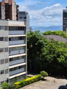 a tall building in front of some buildings at João Machado Fortes in Florianópolis